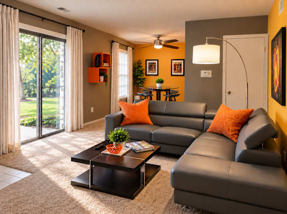 A living room with a grey couch and a coffee table.