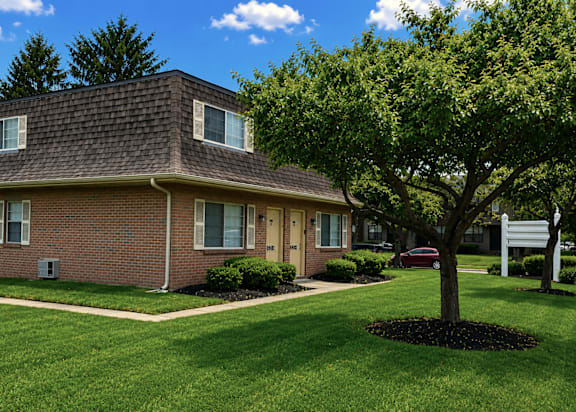A house with a tree in front of it.