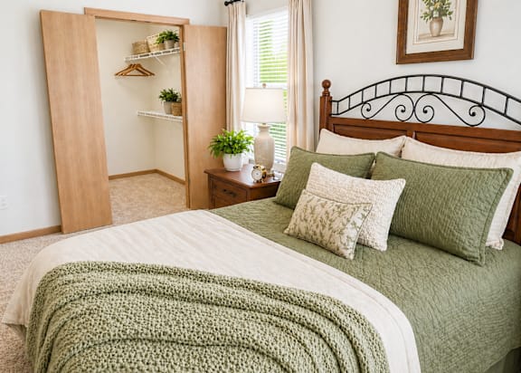 A bedroom with a bed, a nightstand, and a wardrobe.