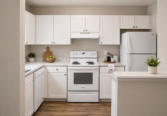 A white kitchen with a stove, oven, and refrigerator.