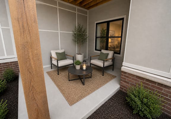 A cozy outdoor seating area with a couch, chairs, and a table.