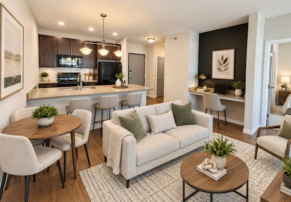 A modern living room with a grey couch and a wooden coffee table.