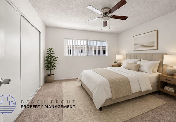 A bedroom with a bed, a ceiling fan, and a plant.