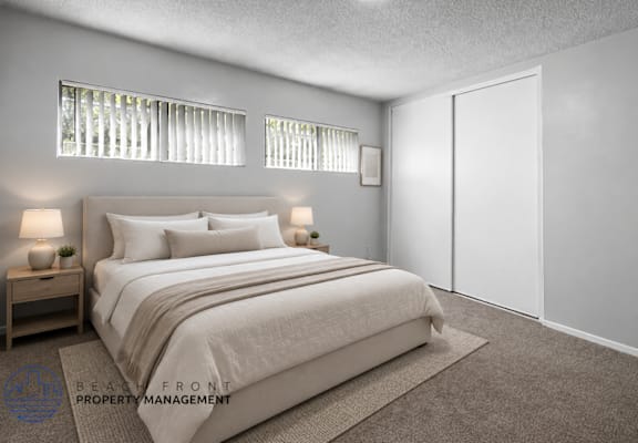 A bedroom with a large bed, two nightstands, and a carpeted floor.