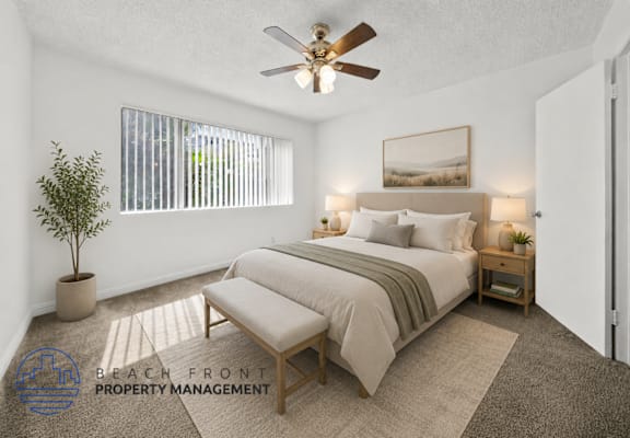 A bedroom with a bed, a bench, and a ceiling fan.