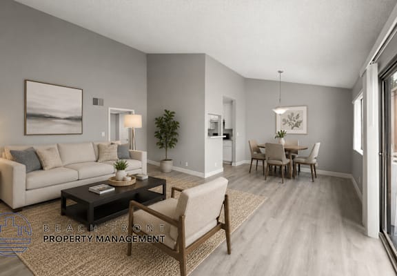 A living room with a couch, coffee table, and chairs.