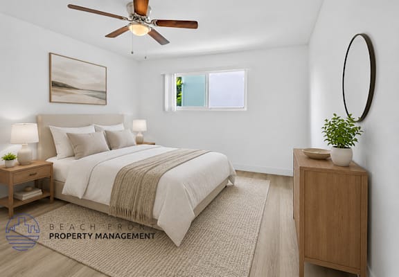 A bedroom with a bed, nightstand, and a ceiling fan.