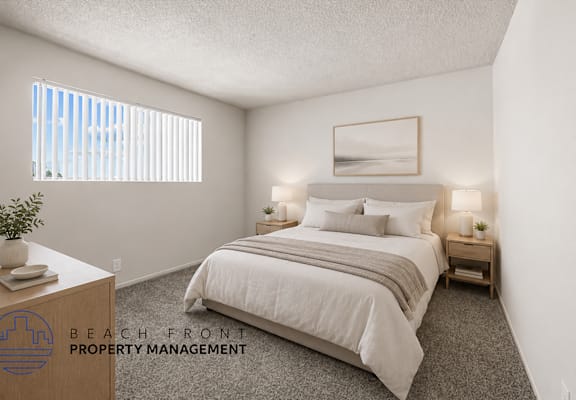 A bedroom with a bed, nightstands, and a window with blinds.