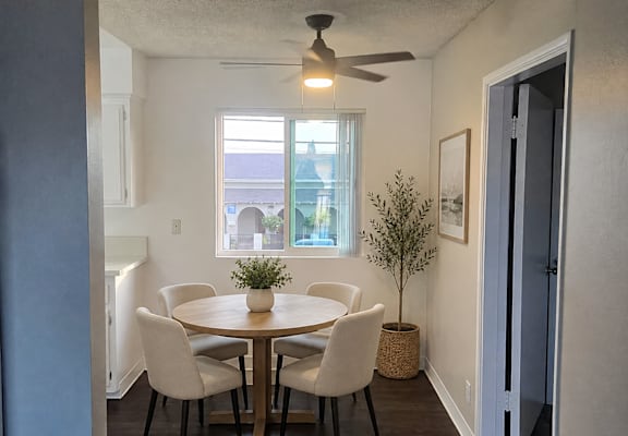 A dining room with a round table and chairs.