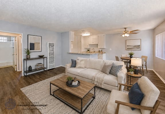A living room with a white couch and a coffee table.