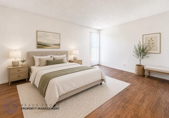 A well-lit bedroom with a large bed and a small tree.