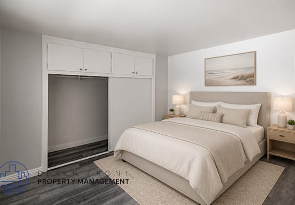 A bedroom with a large bed, a fireplace, and a painting on the wall.