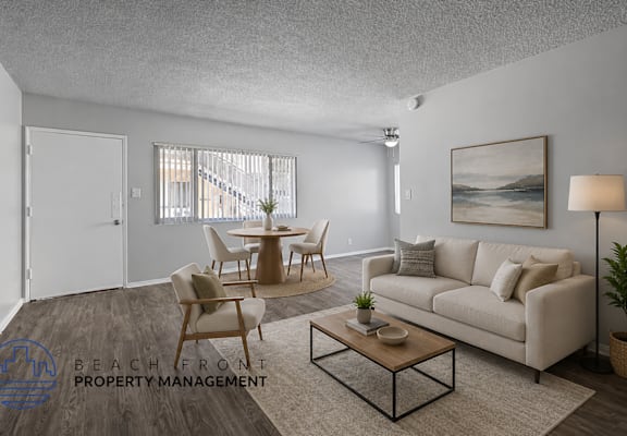 A living room with a couch, chairs, and a coffee table.