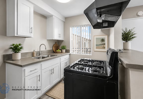 A modern kitchen with a black stove top oven.