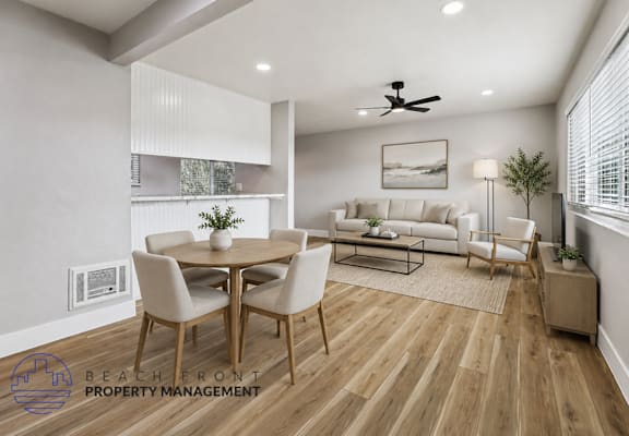 A well-lit, modern dining room with a wooden floor and a white ceiling fan.