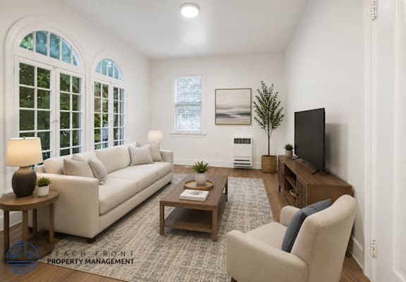 A living room with a couch, chair, and television.