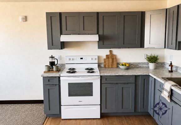 A white stove top oven with a pot on it.