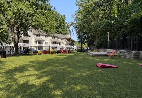 A park with a red object on the grass.
