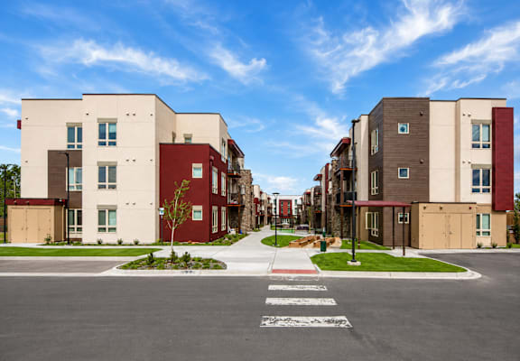 A street view of a residential area with apartment buildings on both sides.