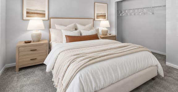 Comfortable bedroom with neutral finishes at Southwinds Point Apartments offering pet-friendly one, two and three bedroom apartment homes in Stockbridge, GA.