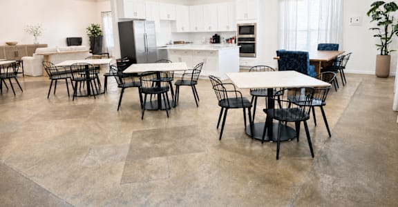 A spacious kitchen and dining area with a table set for six.