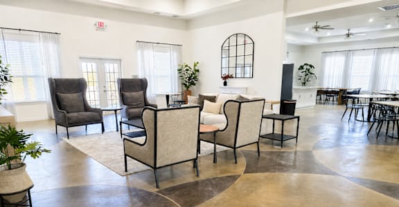 A living room with a circular concrete floor and a fireplace.