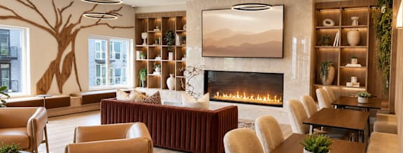 A living room with a fireplace and a large painting on the wall.