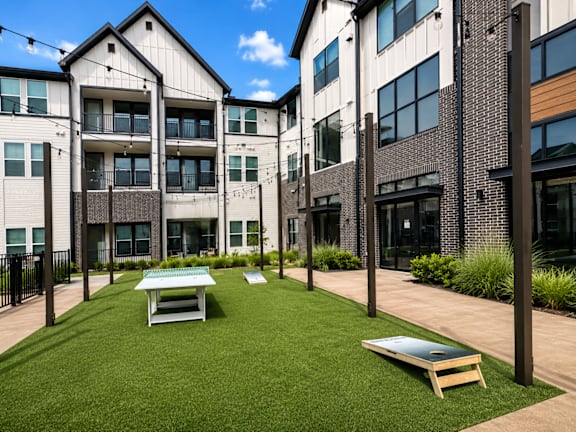 Outdoor lawn games and gathering space at The Bluewood
