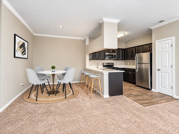 A kitchen with a table and chairs in the middle of the room.