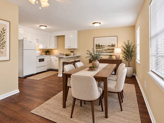 A kitchen with a dining table and chairs at Signature Collection in Tuscaloosa, AL, 35405.