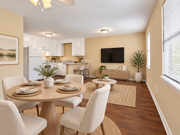 A well-lit dining room with a table set for four at Signature Collection in Tuscaloosa, AL, 35405.
