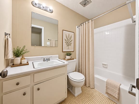 A bathroom with a toilet, sink, and shower at Signature Collection in Tuscaloosa, AL, 35405.