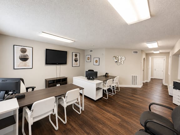 A conference room with a long table and chairs.