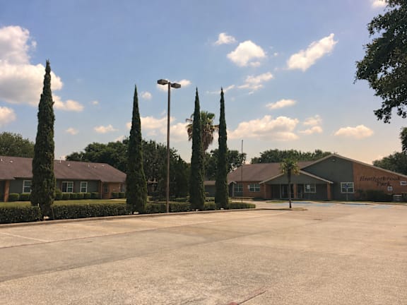 A parking lot in front of a building with a sign that reads "Health and Fitness".