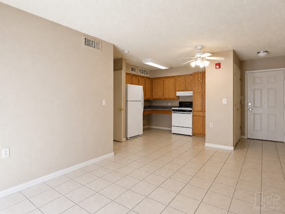 A kitchen area with a refrigerator, oven, and microwave.