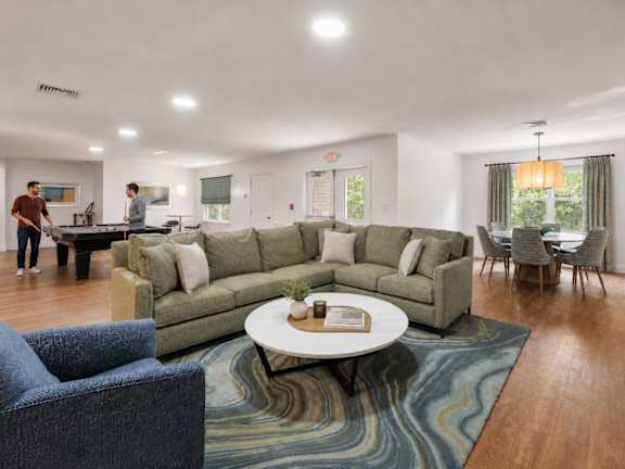 A living room with a green couch and a coffee table.