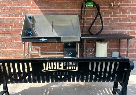a picnic table with a grill on top of it at Imperial Lofts, Sugar Land, 77498