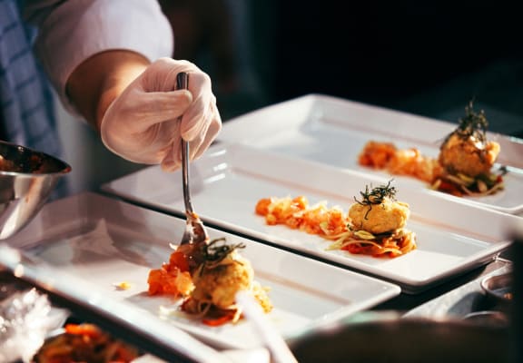 a chef plating up food in a restaurant