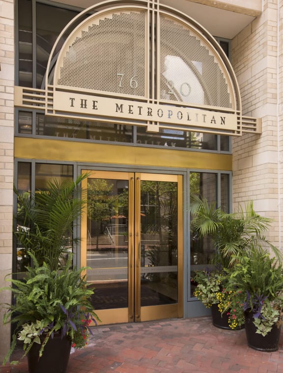 a view of the entrance to the metropolitan building with potted plants