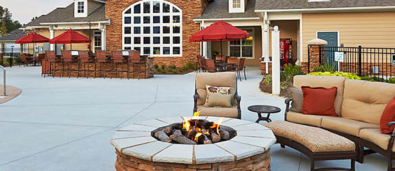 Fire Pit and seating beside Pool  at Tyler's Ridge Apartments in Carthage, NCat  Tyler's Ridge