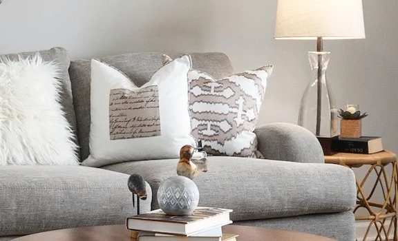 a couch with pillows on it in a living room