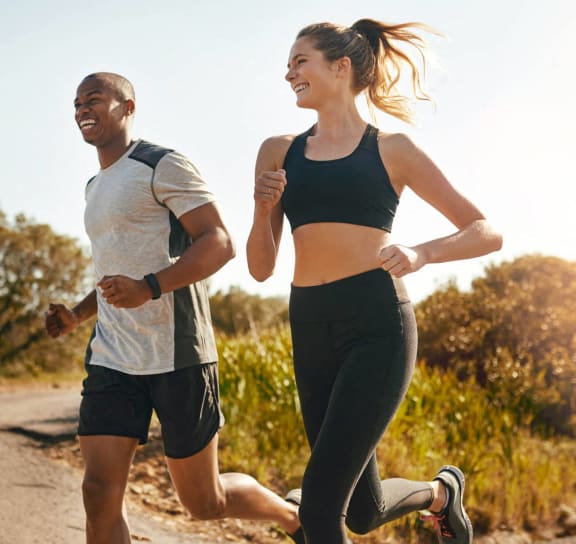 a man and a woman running down a road at Sunscape Apartments, Roanoke