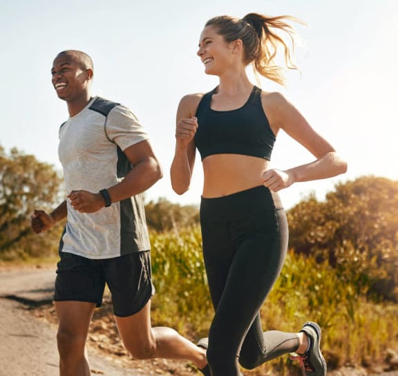 a man and a woman running down the Monon Trail at Avant & Avant II, Carmel, IN