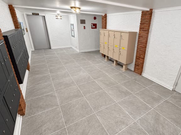A room with a grey tile floor and white walls.