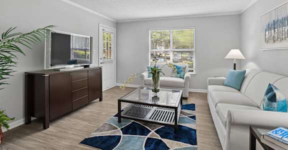 Open-concept living room with natural light at Southwinds Point Apartments near I-75 in Stockbridge, GA.