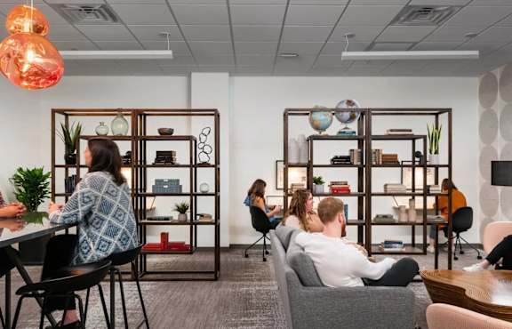 a group of people sitting at a table in an office