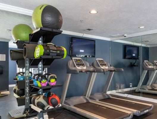 a gym with treadmills and other exercise equipment