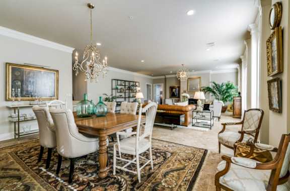 A dining room with a wooden table and chairs.