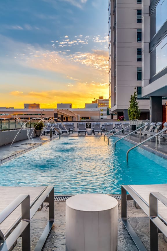 a pool on the roof of a building with a city in the background at The Grand Central, Chicago Illinois