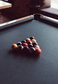 A pool table with a red ball in the middle  at Cru at Willows Apartments, Redmond, Washington